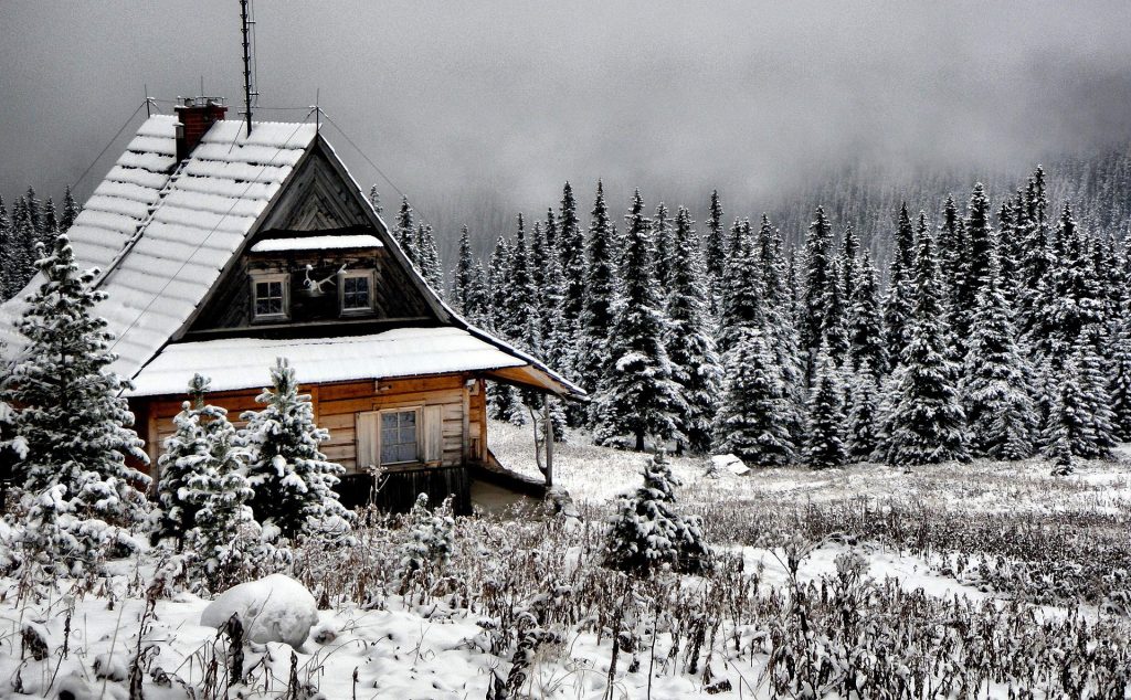 Maison en bois dans paysage de neige